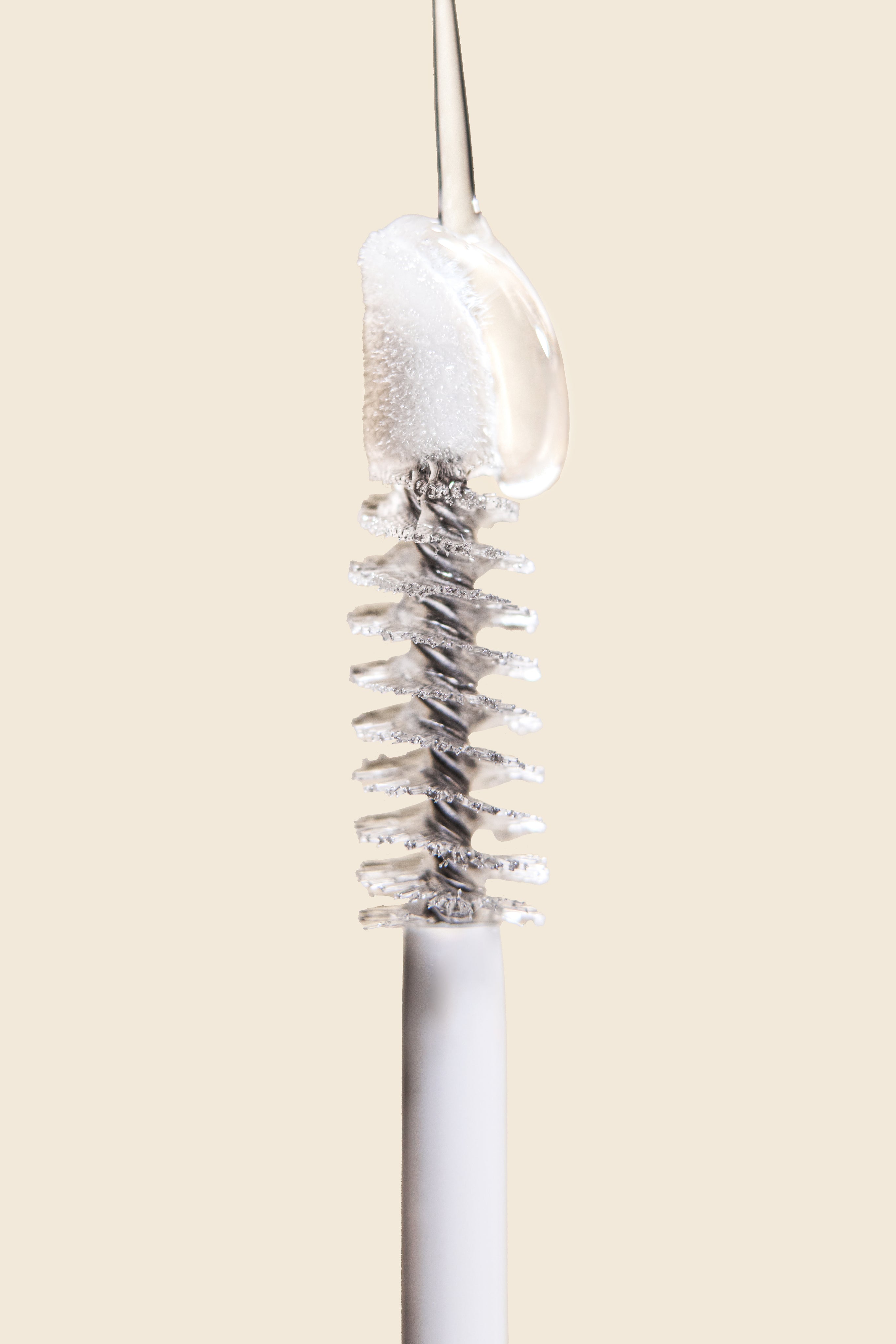 Mascara wand with clear gel close-up.